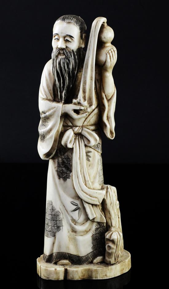 A Japanese walrus ivory figure of a man pouring water from a gourd, early 20th century, height 21cm